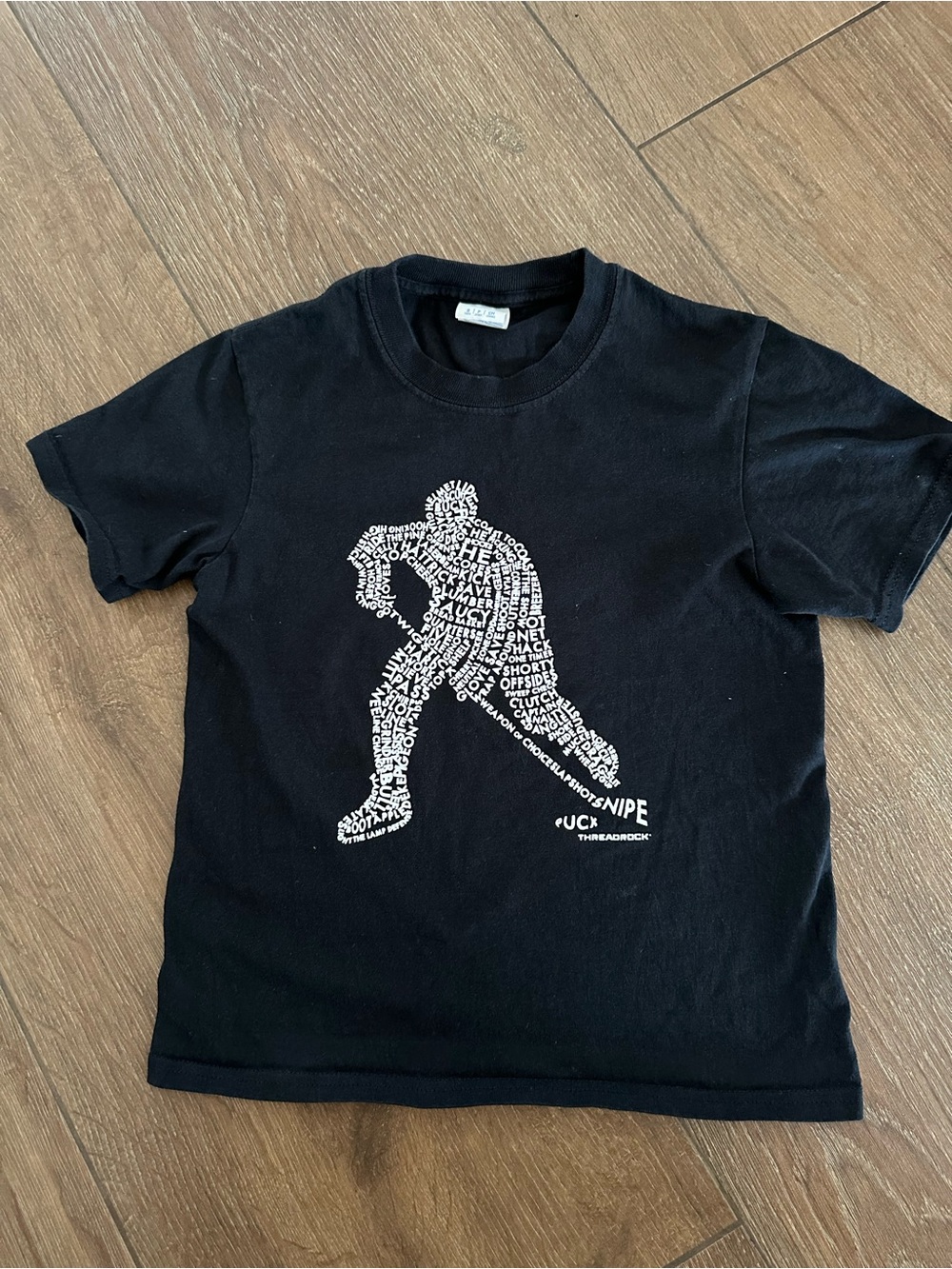 Kids Black Graphic Tee with White Hockey Player Design. Size child S.